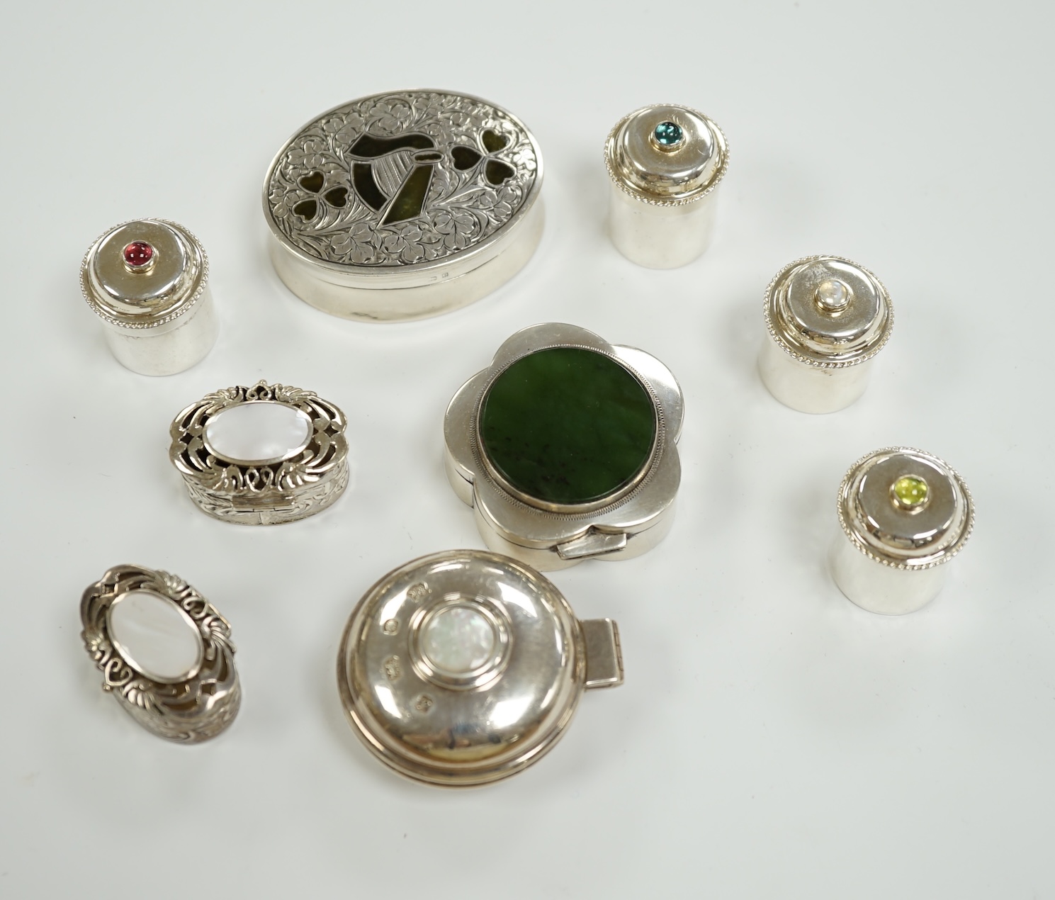 Nine assorted mainly modern silver or white metal and hardstone/cabochon set pill boxes, largest 59mm.